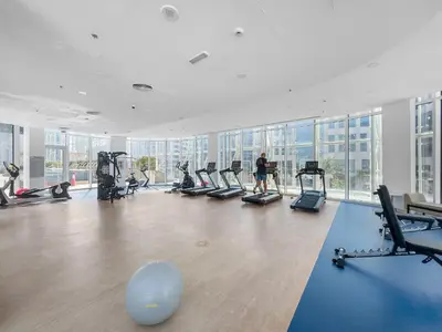 a gym with a person exercising in a gym at InstaWorthy Aesthetic 1BR APT, 5mins to Dubai Mall in Dubai