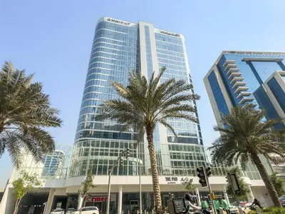 a tall building with palm trees in front of it at InstaWorthy Aesthetic 1BR APT, 5mins to Dubai Mall in Dubai