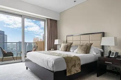 a bedroom with a large bed and a large window at Amazing 1 Bd Marina View LLC in Dubai