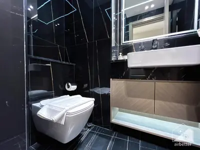 a black bathroom with a toilet and a sink at Chic 1-BR Apt & Balcony in Binghatti Heights in Dubai