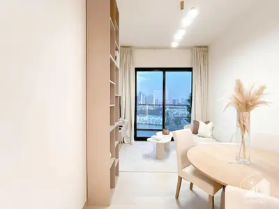 a white living room with a table and a dining room at Chic 1-BR Apt & Balcony in Binghatti Heights in Dubai