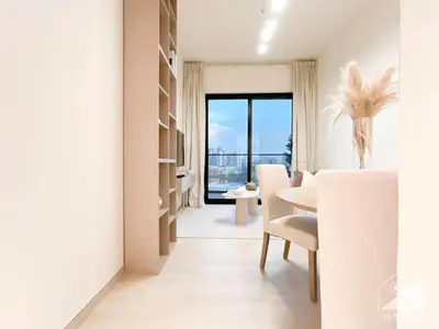 a white dining room with a table and a window at Chic 1-BR Apt & Balcony in Binghatti Heights in Dubai