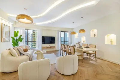 a living room with a table and a dining room at Daniels 2BR at Rimal JBR with Marina View in Dubai