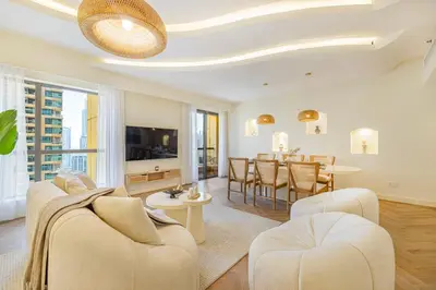 a living room with white furniture and a dining room at Daniels 2BR at Rimal JBR with Marina View in Dubai