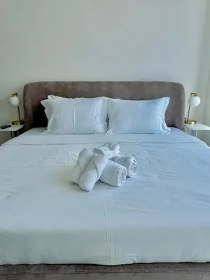 a stuffed animal sitting on a bed with towels at Noma Fairview - Burj Khalifa view stunning apartment in Business Bay in Dubai