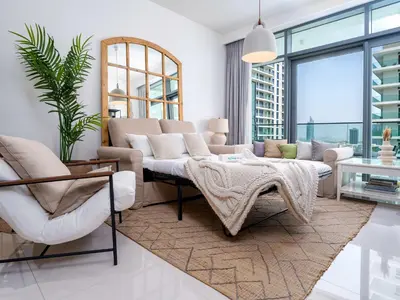 a living room with a couch and a table at Luxury Living in Emaar Beachfront w Private Beach in Dubai