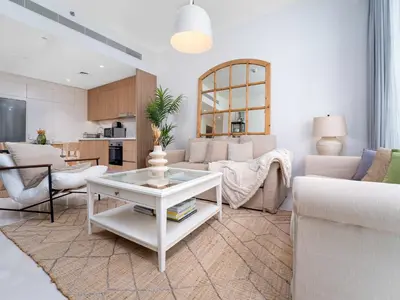 a living room with a couch and a table at Luxury Living in Emaar Beachfront w Private Beach in Dubai