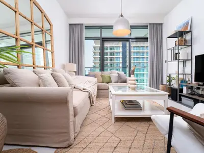 a living room with a couch and a table at Luxury Living in Emaar Beachfront w Private Beach in Dubai