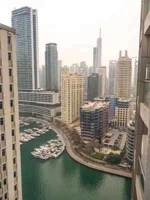 a view of a river with boats in a city at Luxury two bedrooms with Jbr and Marina view apartment in Dubai
