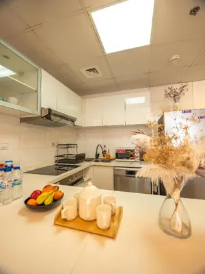 a kitchen with a table with a plate of fruit on it at Luxury two bedrooms with Jbr and Marina view apartment in Dubai