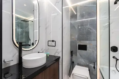 a bathroom with a sink and a shower at The Luxe Marina Experience - Stylish 2BR with Sweeping Balcony Views for Total Relaxation in Dubai