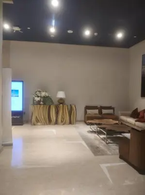 a living room with couches and a flat screen tv at LeModCasa - Modern Chic studio in Dubai