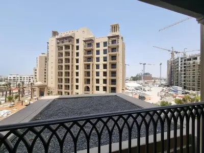 a view of a building from a balcony at 1BD Partial Burj Al Arab View Prime Location in Dubai