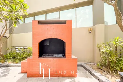 a brick fireplace in front of a building at LUX The Voleo Canal View Suite in Dubai