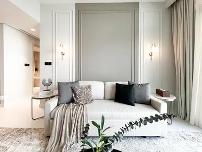 a white living room with a white couch at Trophy Luxury 1BDR in Emaar Beach Front with Panoramic Sea Views from the Apartment and Private Beach Access in Dubai