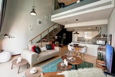 a living room with a couch and a table at Blueground DIFC marina view pool gym DXB-21 in Dubai