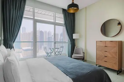 a bedroom with a bed and a large window at Blueground DIFC swimming pool gym security DXB-1545 in Dubai