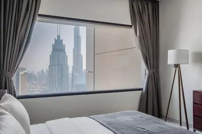a bedroom with a large window with a city view at Blueground DIFC Burj K views indoor pool DXB-1493 in Dubai