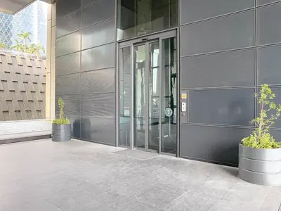 a building with two potted plants in front of it at Blueground DIFC Burj K views indoor pool DXB-1493 in Dubai