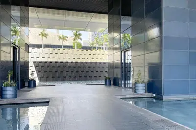 a lobby of a building with a pool of water at Blueground DIFC Burj K views indoor pool DXB-1493 in Dubai