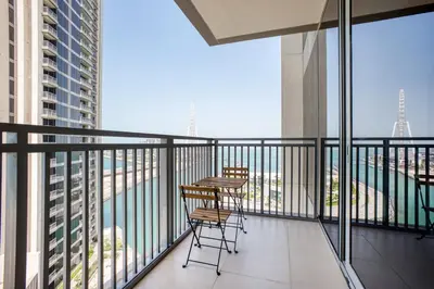 a balcony with two chairs and a table on it at Blueground 5242 Tower sea view doorman pool DXB-867 in Dubai