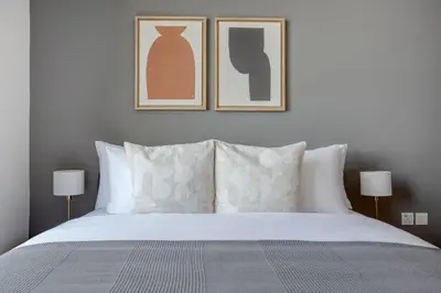 a bedroom with a bed with two pictures on the wall at Blueground 5242 Tower sea view doorman pool DXB-867 in Dubai