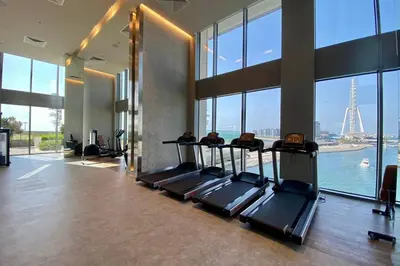 a gym with a view of the eiffel tower at Blueground 5242 Tower sea view doorman pool DXB-867 in Dubai