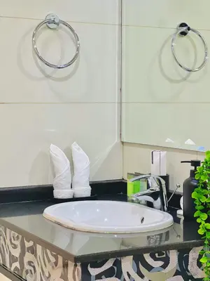 a bathroom with a sink with towels on a counter at Waves - Executive Bay Studio, Canal View and Modern Amenities in Dubai