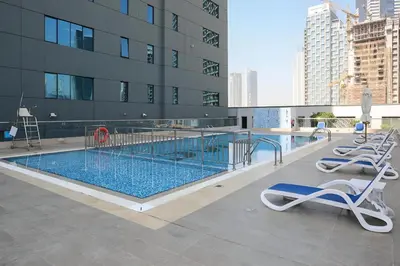 a swimming pool on the roof of a building at Waves - Executive Bay Studio, Canal View and Modern Amenities in Dubai