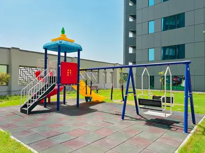a playground with a slide and a swing at Waves - Executive Bay Studio, Canal View and Modern Amenities in Dubai