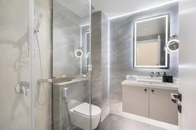 a bathroom with a shower and a toilet and a sink at Palm Home next to Nakheel Mall with Private Beach in Dubai