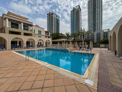 a large swimming pool in a building with tall buildings at Frank Porter - Arno A in Dubai