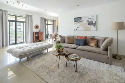 a living room with a couch and a table at Frank Porter - Arno A in Dubai