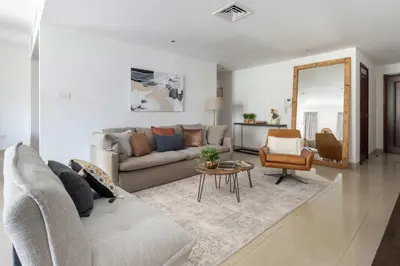 a living room with a couch and a table at Frank Porter - Arno A in Dubai