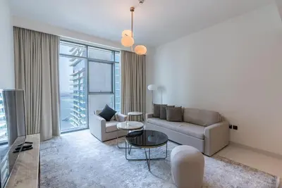 a living room with a couch and a table at Beachfront Holiday 1BR Sea Marina Views in Dubai