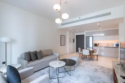 a living room with a couch and a table at Beachfront Holiday 1BR Sea Marina Views in Dubai