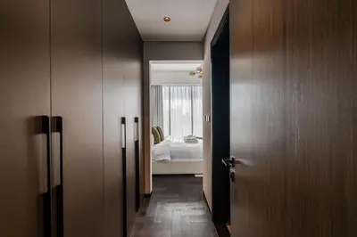 a hallway with a room with a bed and a door at Stylish 1BR with Dubai Skyline & Burj Khalifa View in Dubai