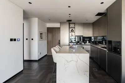 a kitchen with a white counter in a room at Stylish 1BR with Dubai Skyline & Burj Khalifa View in Dubai