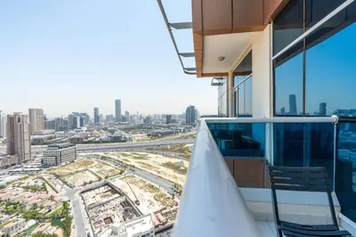 a balcony of a building with a view of a city at Nice studio in JVT - Al Manara Tower - Dubai in Dubai