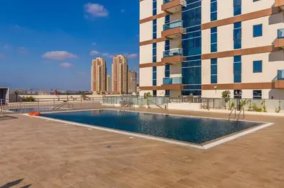 a swimming pool on the roof of a building at Nice studio in JVT - Al Manara Tower - Dubai in Dubai