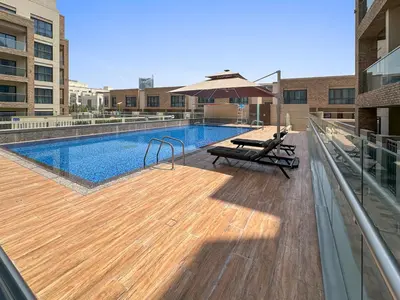 a swimming pool on top of a building at Brand New 2 Br Apartment In Family Community in Dubai