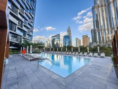 a large swimming pool with a city skyline in the background at Address Residence Opera, Downtown, Dubai in Dubai