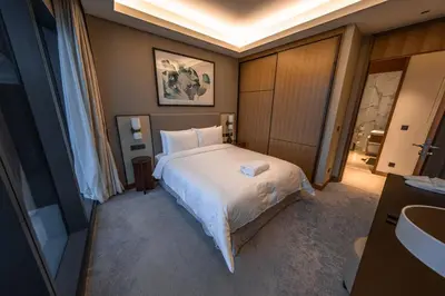 a bedroom with a large white bed and a sink at Address Residence Opera, Downtown, Dubai in Dubai