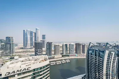a view of a city with a river and buildings at Special Deal 2BR with Canal Views & Relaxing Balcony by Deluxe Holiday Homes in Dubai