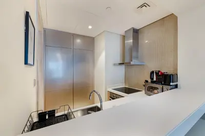 a kitchen with a sink and a counter top at ALiving Modern & Chic 1BR I Paramount Tower D -2203 in Dubai