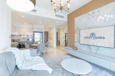 a living room with a couch and a table at Luxury Home on the 50th Floor with Full Burj View in Dubai