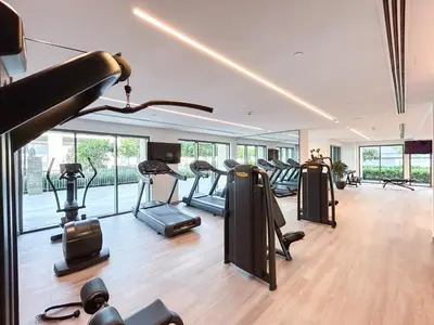 a gym with a bunch of treadmills and ellipticals at Luxury Home on the 50th Floor with Full Burj View in Dubai
