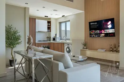 a living room with a couch and a tv on a wall at Burj Khalifa View Big terrace 1BR in Prime Views in Dubai