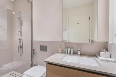 a bathroom with a sink and a shower at Creekside Bliss 1BR with Beach Access Summer 3 in Dubai