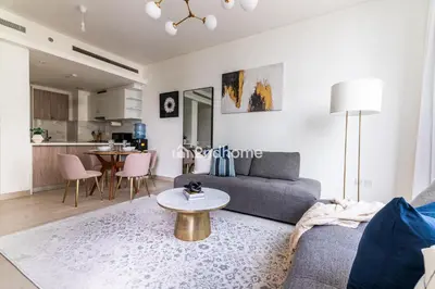 a living room with a couch and a table at Fully Equipped Residence at One Park Avenue in Dubai